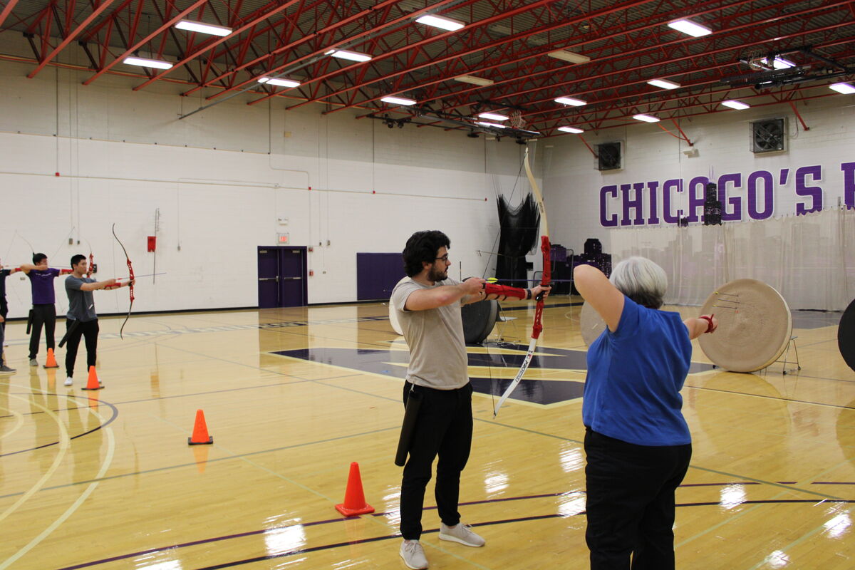 Our coach helping an archer with their form